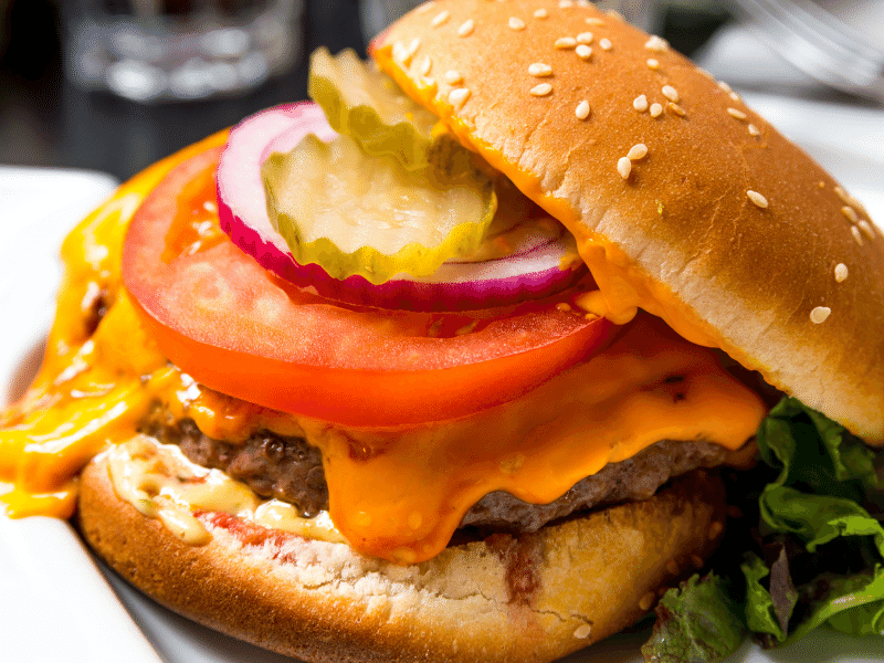 hamburger with melting cheese tomato pickle